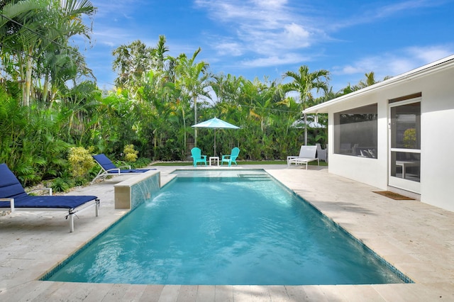 view of swimming pool featuring a sunroom, pool water feature, and a patio