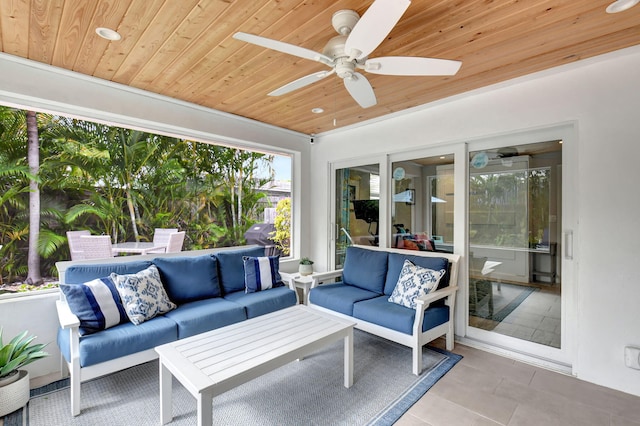 sunroom with ceiling fan and wood ceiling