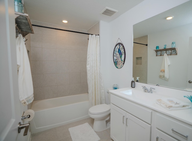 full bathroom with tile patterned flooring, shower / bath combo, vanity, and toilet