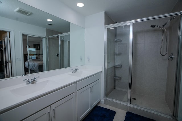 bathroom featuring vanity, a textured ceiling, and walk in shower