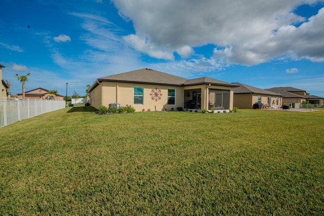 rear view of property with a yard