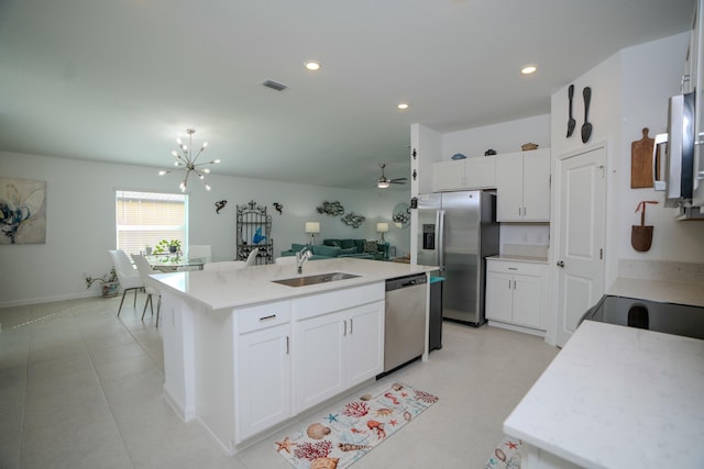 kitchen featuring white cabinetry, sink, an island with sink, and appliances with stainless steel finishes