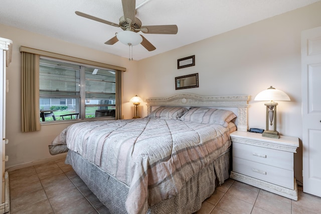 bedroom featuring tile patterned floors and ceiling fan