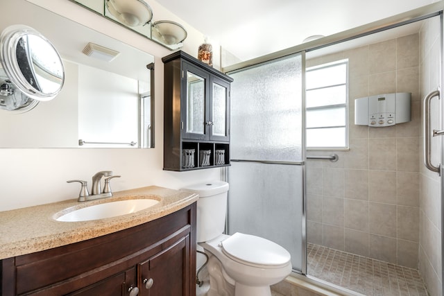 bathroom with vanity, toilet, and an enclosed shower