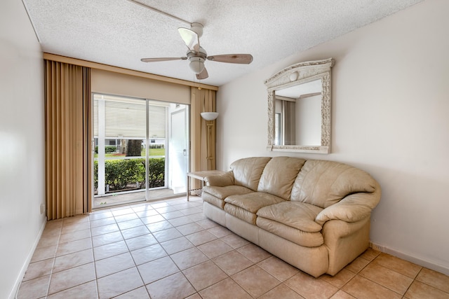 tiled living room with a textured ceiling and ceiling fan