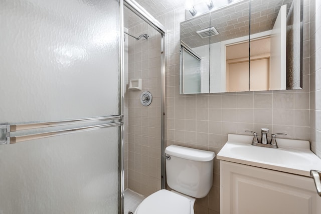 bathroom featuring vanity, backsplash, toilet, tile walls, and an enclosed shower