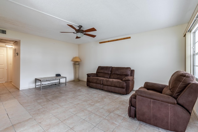 living room featuring light tile patterned floors and ceiling fan