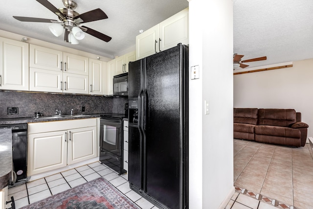 kitchen featuring backsplash, a textured ceiling, sink, black appliances, and light tile patterned floors