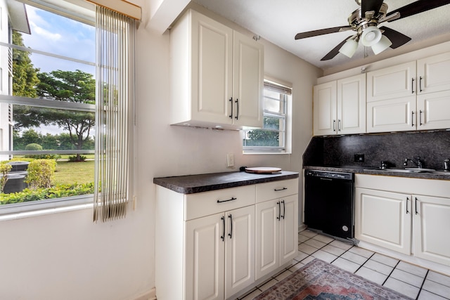 kitchen featuring tasteful backsplash, ceiling fan, sink, dishwasher, and white cabinetry