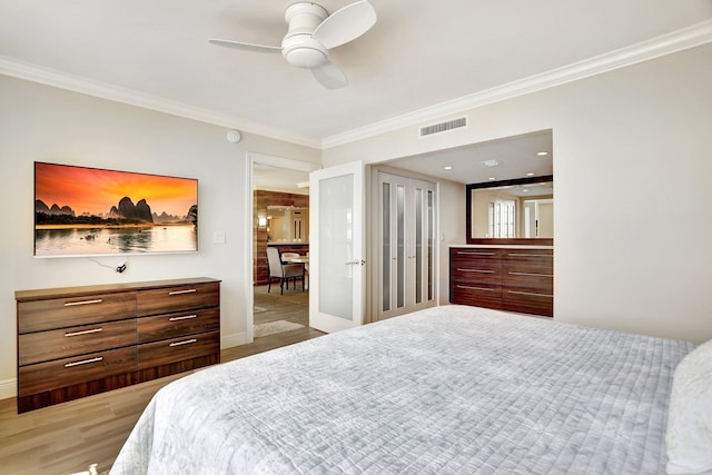 bedroom with ceiling fan, french doors, crown molding, and light hardwood / wood-style flooring