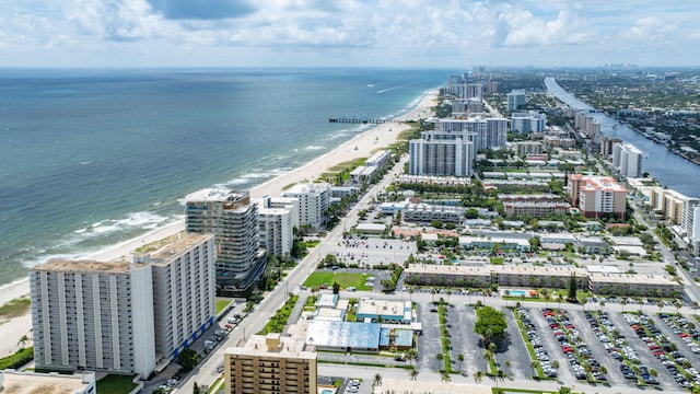 drone / aerial view featuring a water view and a view of the beach