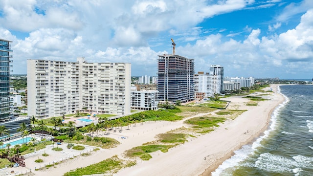 birds eye view of property featuring a beach view and a water view