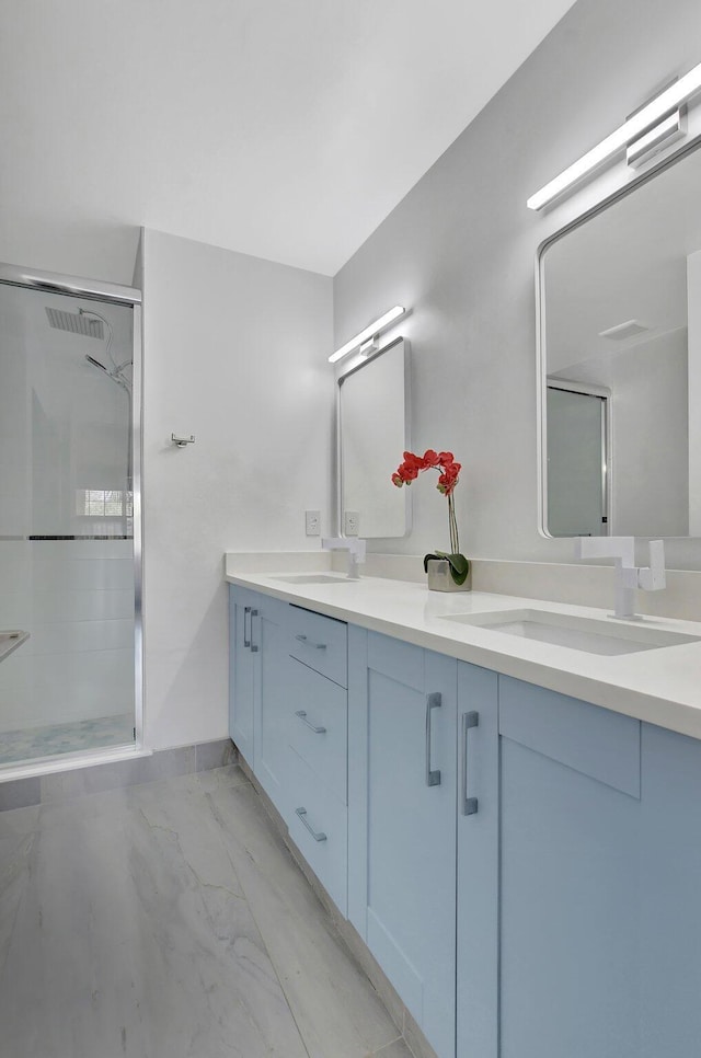 bathroom with vanity and a shower with shower door