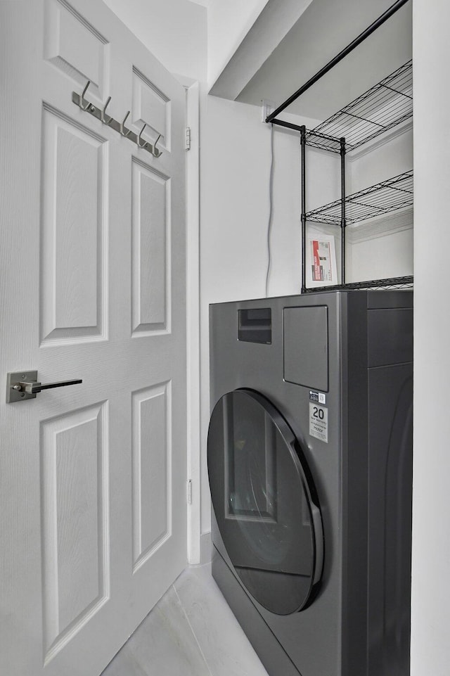 clothes washing area with washer / clothes dryer