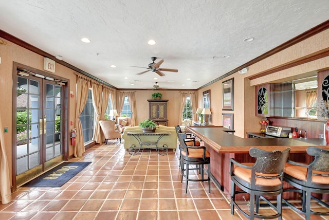 dining space featuring ceiling fan, ornamental molding, light tile patterned floors, and french doors