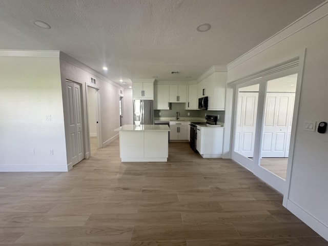 kitchen featuring stainless steel refrigerator with ice dispenser, light wood-type flooring, white cabinets, a center island, and white range with electric cooktop