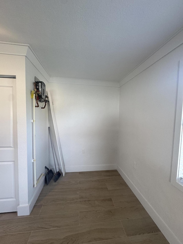 empty room with dark wood-type flooring and a textured ceiling