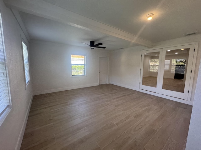 unfurnished room featuring ceiling fan, hardwood / wood-style floors, and a textured ceiling