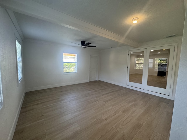 spare room featuring ceiling fan, hardwood / wood-style floors, crown molding, and a textured ceiling