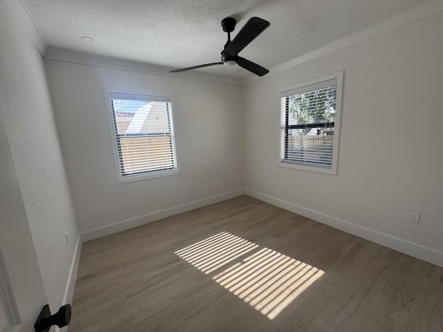 unfurnished room with ceiling fan, ornamental molding, and light wood-type flooring