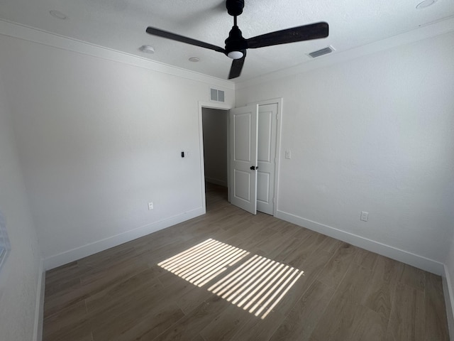 3015 Robert Rd, West Palm Beach, FL 33405 - unfurnished room featuring wood-type flooring, ornamental molding, a textured ceiling, and ceiling fan