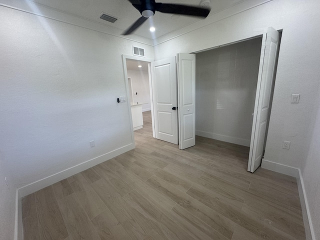 unfurnished bedroom featuring ceiling fan and light hardwood / wood-style flooring