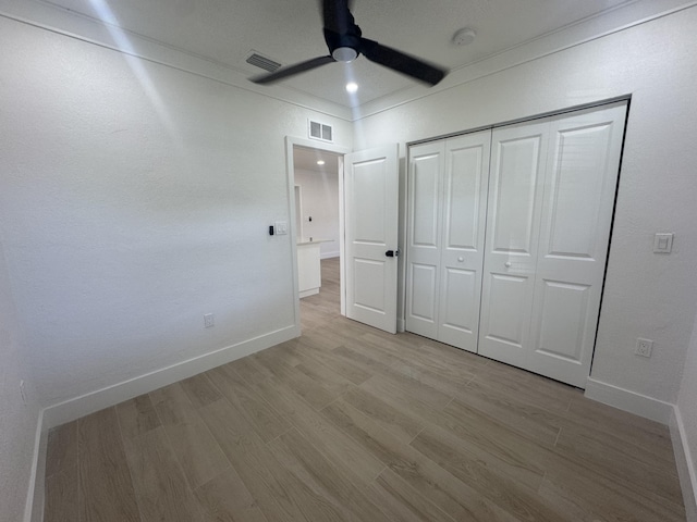 3015 Robert Rd, West Palm Beach, FL 33405 - unfurnished bedroom with ceiling fan, light wood-type flooring, and a closet