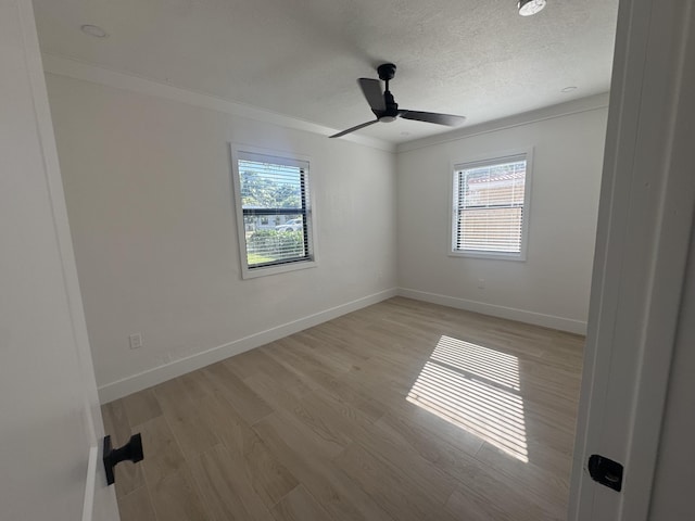 unfurnished room with a textured ceiling, light hardwood / wood-style floors, ceiling fan, and ornamental molding