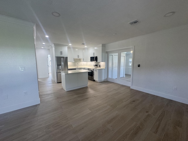 3015 Robert Rd, West Palm Beach, FL 33405 - kitchen featuring sink, white cabinetry, a center island, light wood-type flooring, and stainless steel appliances