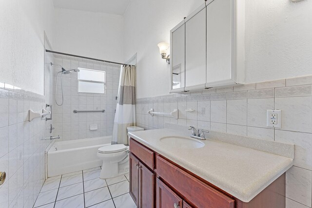 full bathroom featuring toilet, tile patterned floors, vanity, and shower / tub combo with curtain