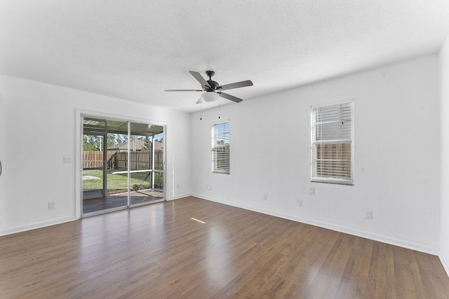 unfurnished room with ceiling fan, dark hardwood / wood-style flooring, and a textured ceiling