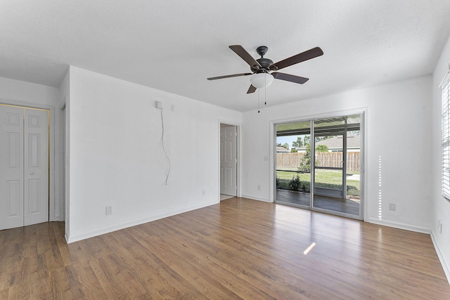 spare room featuring wood-type flooring, a textured ceiling, and ceiling fan