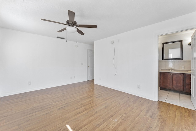 spare room featuring ceiling fan and light wood-type flooring