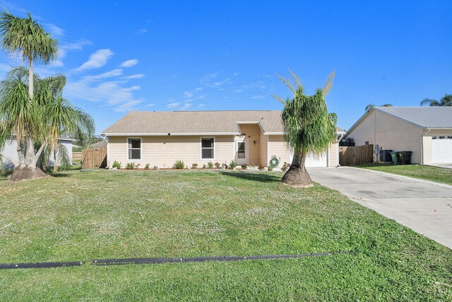 ranch-style house featuring a garage and a front yard