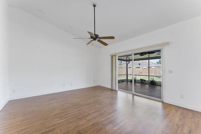 spare room featuring wood-type flooring, vaulted ceiling, and ceiling fan