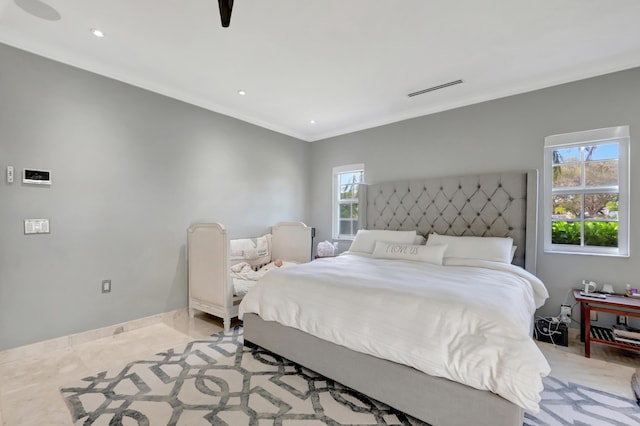 bedroom featuring light tile patterned floors and multiple windows