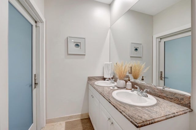 bathroom featuring tile patterned flooring and vanity