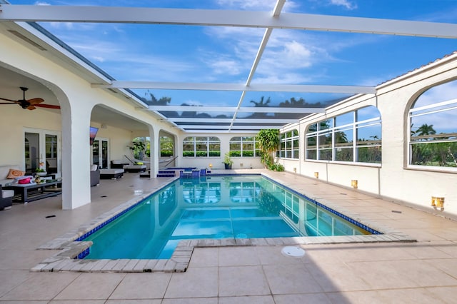 view of swimming pool featuring a lanai, outdoor lounge area, and a patio