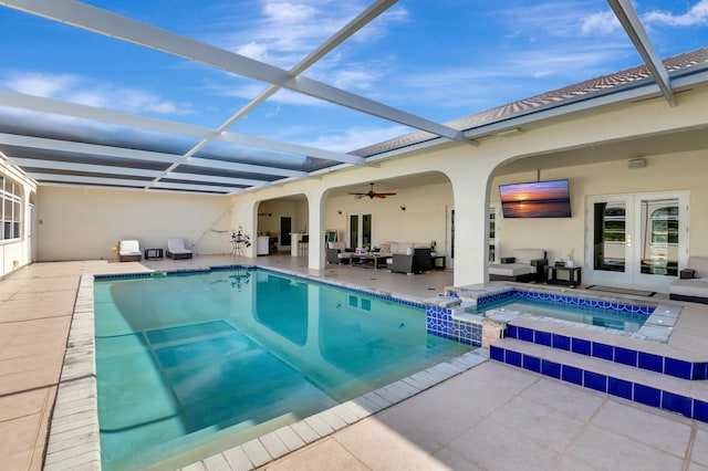 view of pool with an in ground hot tub, an outdoor living space, glass enclosure, and a patio