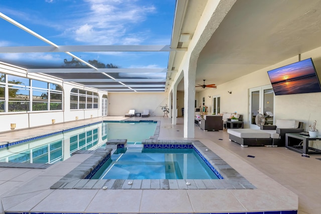 view of pool featuring glass enclosure, an in ground hot tub, outdoor lounge area, and a patio area