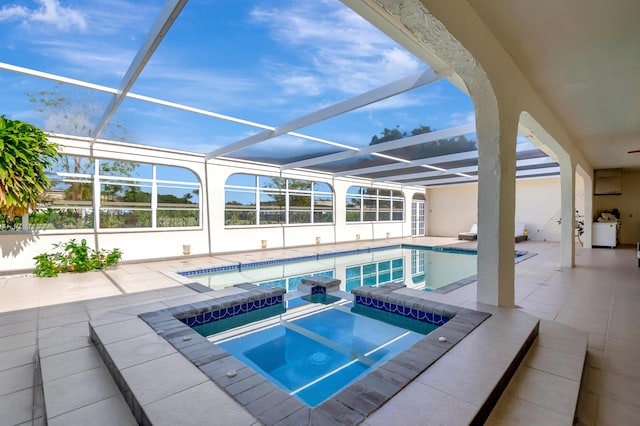 view of pool featuring an in ground hot tub, a patio area, and a lanai