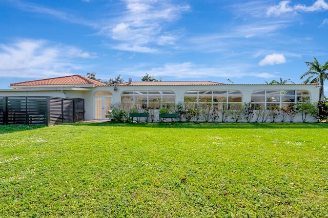 rear view of house with a yard