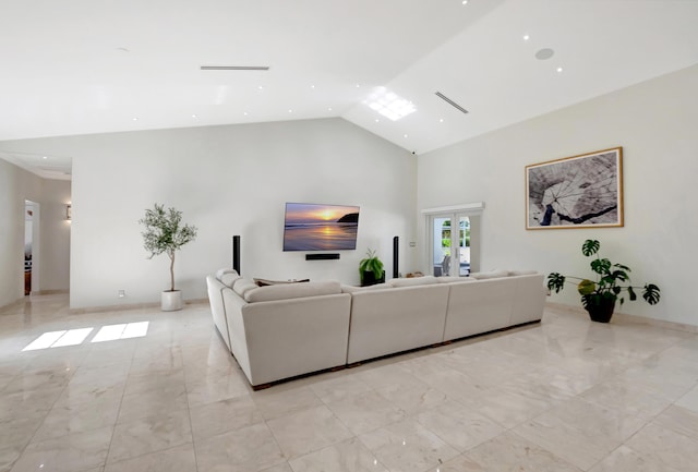 living room with high vaulted ceiling