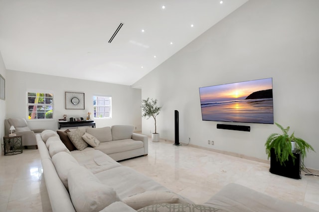 living room with high vaulted ceiling