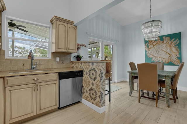 kitchen with sink, stainless steel dishwasher, backsplash, pendant lighting, and light brown cabinetry