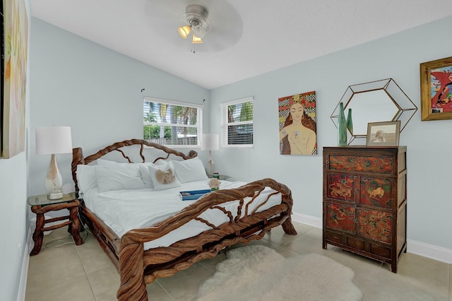 tiled bedroom with ceiling fan and lofted ceiling