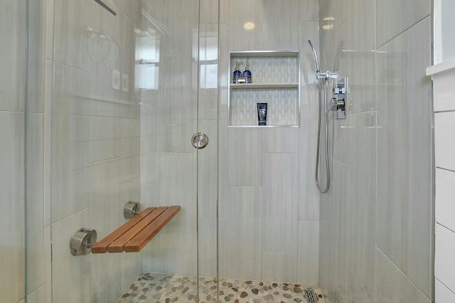 bathroom featuring a shower with door