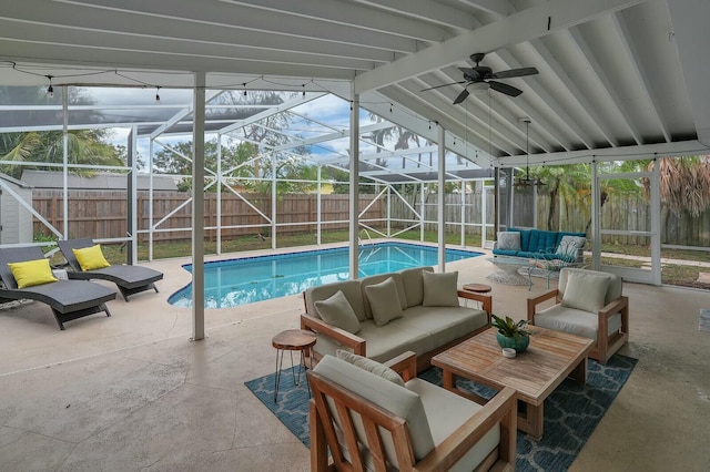 view of pool with an outdoor living space, a patio, and a lanai