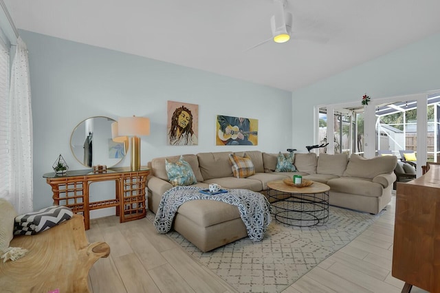 living room featuring ceiling fan and lofted ceiling