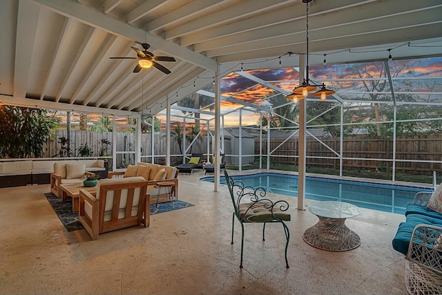 view of swimming pool with glass enclosure, an outdoor living space, a patio area, and a storage shed